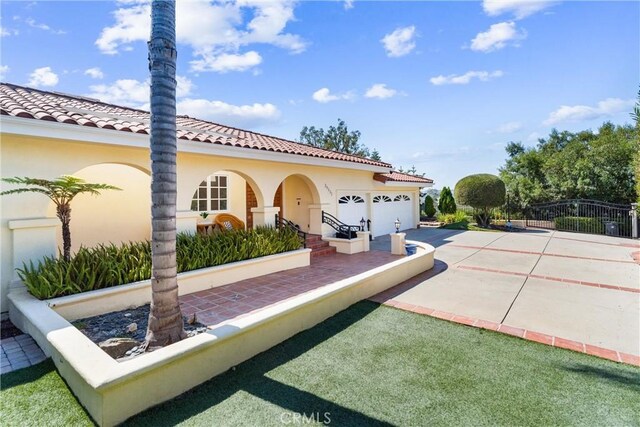 view of patio featuring a garage and concrete driveway