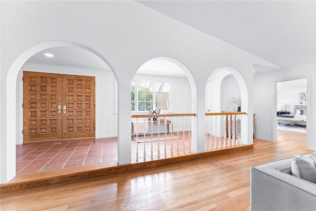 foyer featuring recessed lighting, lofted ceiling, and wood finished floors