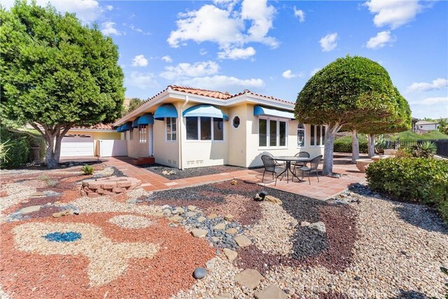 rear view of house with a patio area and a garage