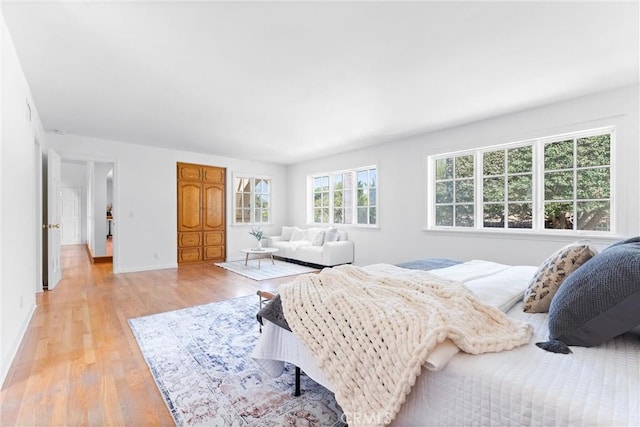 bedroom with light wood-style flooring and baseboards