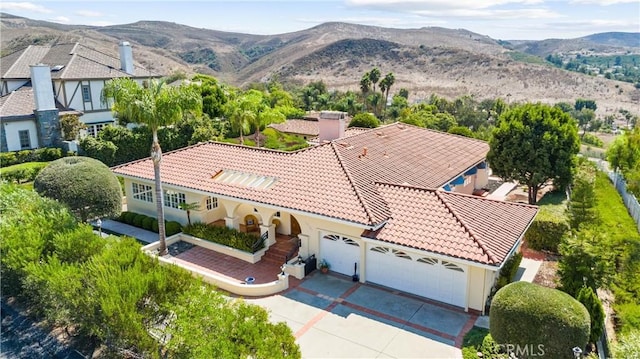 birds eye view of property with a mountain view