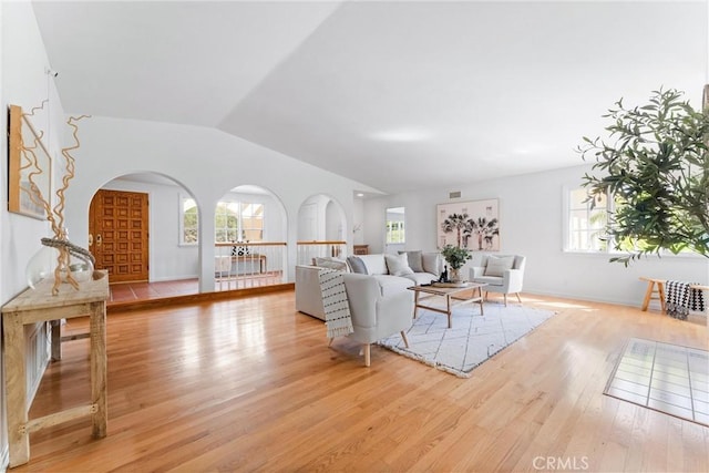 living room featuring vaulted ceiling and light hardwood / wood-style floors