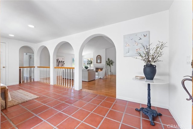 hallway featuring tile patterned floors, recessed lighting, and baseboards