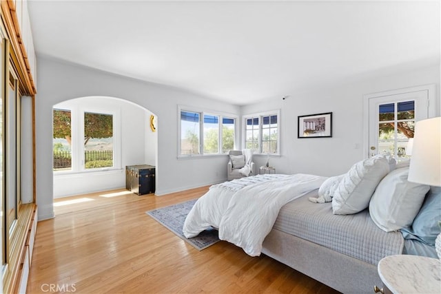 bedroom with light wood-style flooring and access to outside