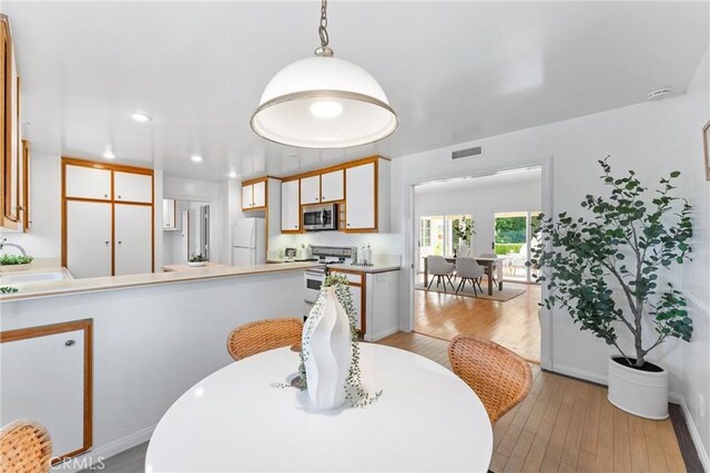 dining room with light wood-style flooring, recessed lighting, visible vents, and baseboards