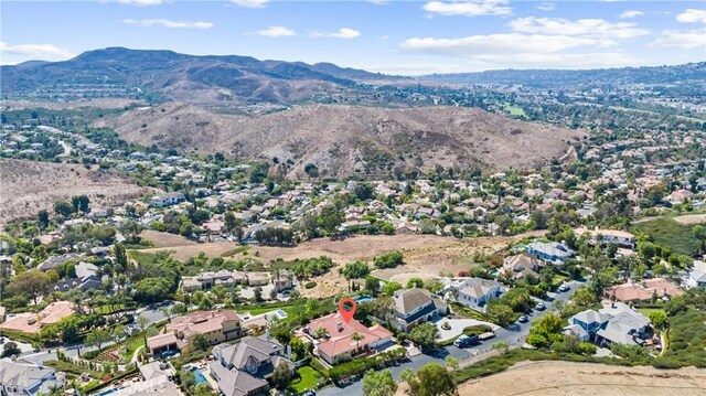 birds eye view of property with a mountain view and a residential view