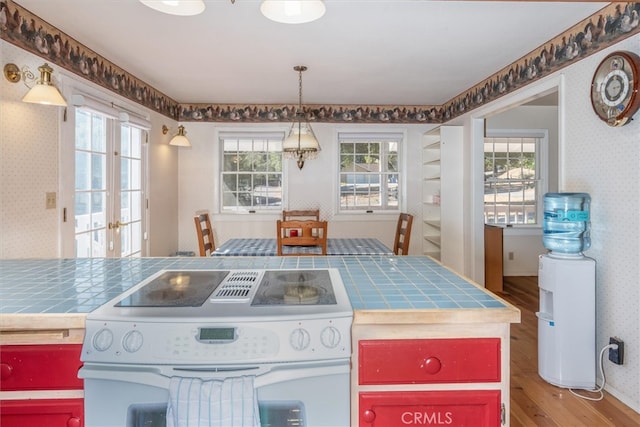 kitchen featuring french doors, tile countertops, light hardwood / wood-style floors, and white range with electric stovetop