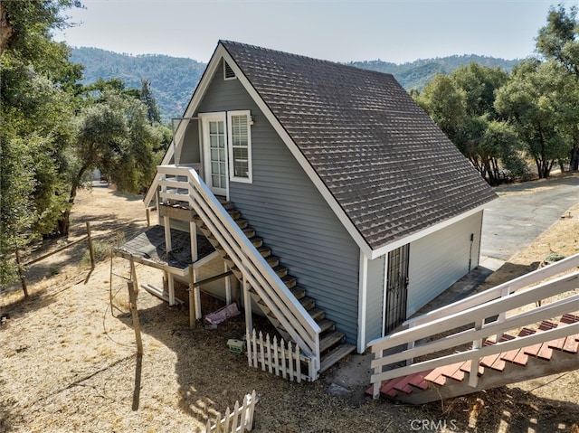 view of side of home with a mountain view