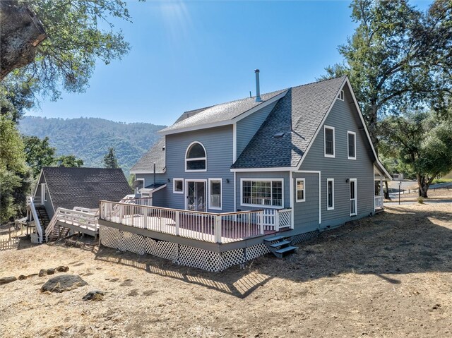 back of house with a deck with mountain view