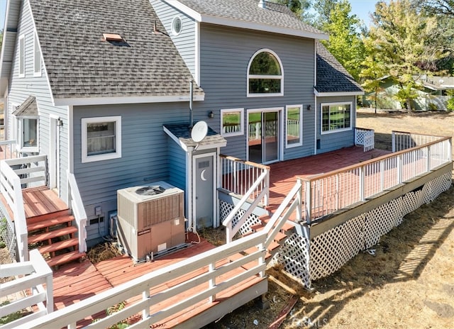 back of property with central AC and a deck