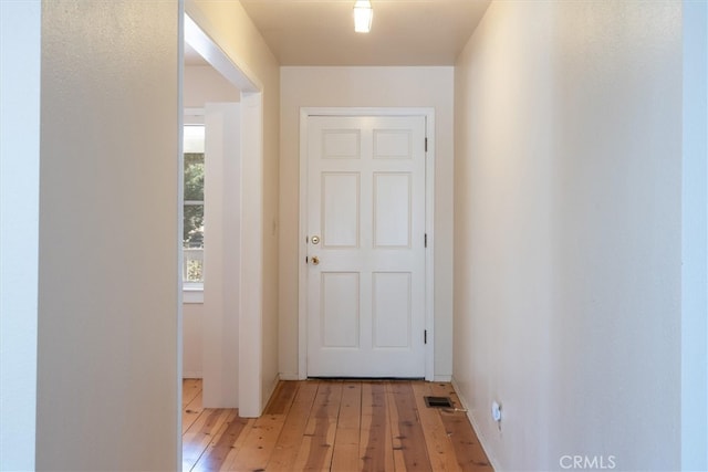 corridor with light hardwood / wood-style flooring