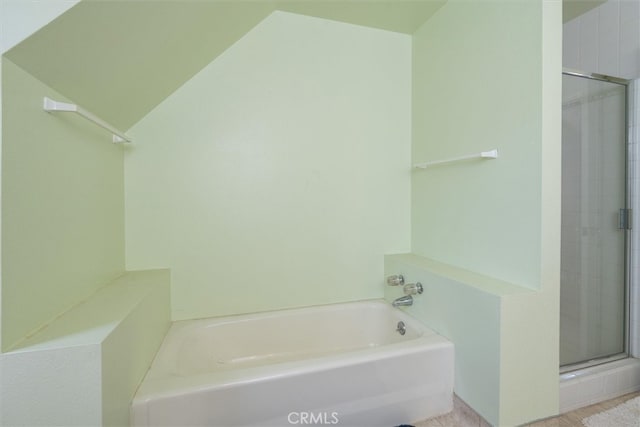 bathroom with separate shower and tub and vaulted ceiling