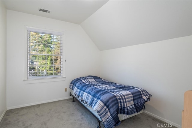 bedroom featuring light carpet and lofted ceiling