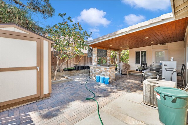 view of patio / terrace featuring a storage unit