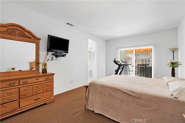 bedroom with access to outside, dark carpet, and ensuite bathroom