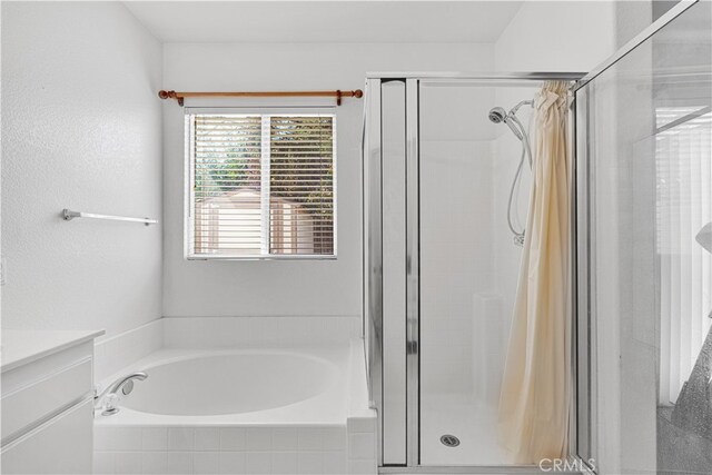 bathroom with vanity and separate shower and tub