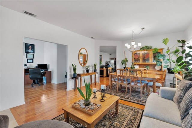 living room featuring a notable chandelier and hardwood / wood-style flooring