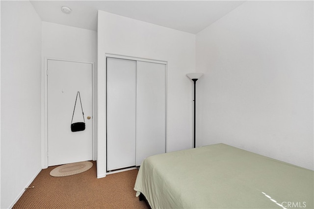 carpeted bedroom with a closet