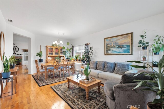 living room with a chandelier and hardwood / wood-style flooring