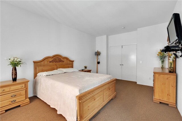 bedroom with light colored carpet and a closet