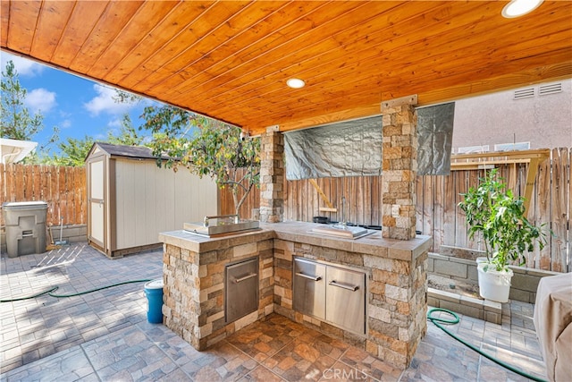 view of patio / terrace featuring a storage unit