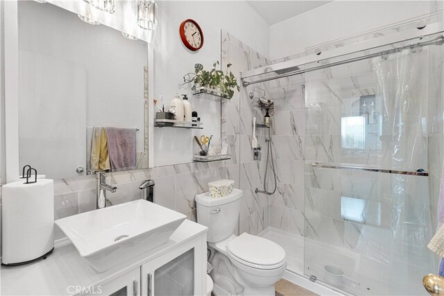 bathroom featuring vanity, tile walls, toilet, and curtained shower