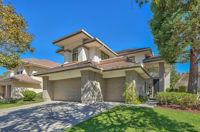 view of front of house featuring a garage and a front yard