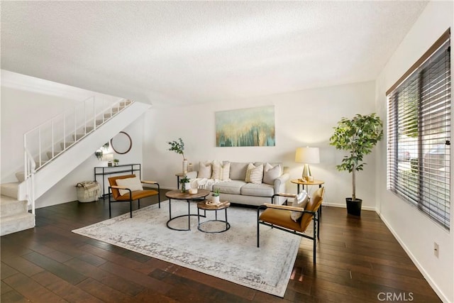 living room with dark hardwood / wood-style floors and a textured ceiling