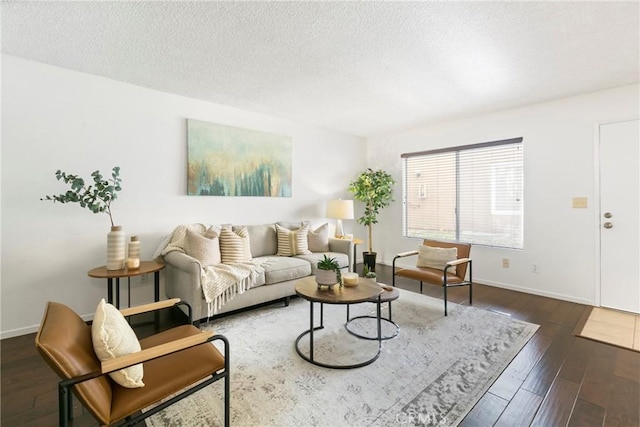 living room with dark hardwood / wood-style flooring and a textured ceiling