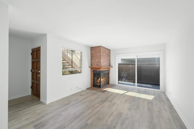 unfurnished living room featuring a fireplace and light wood-type flooring