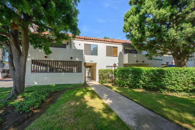 mediterranean / spanish-style home with a front lawn