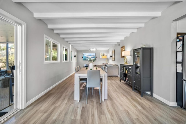 dining room featuring beamed ceiling and light hardwood / wood-style floors