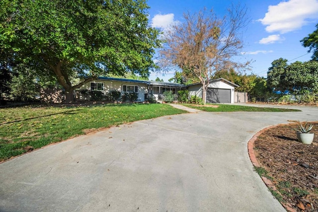 single story home with a garage and a front lawn