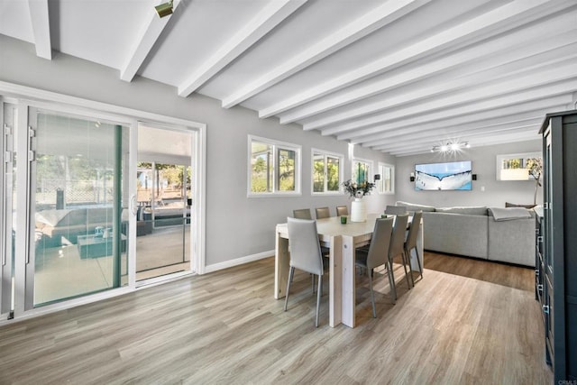 dining space featuring beam ceiling and light hardwood / wood-style floors