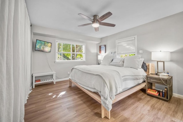 bedroom featuring hardwood / wood-style flooring and ceiling fan