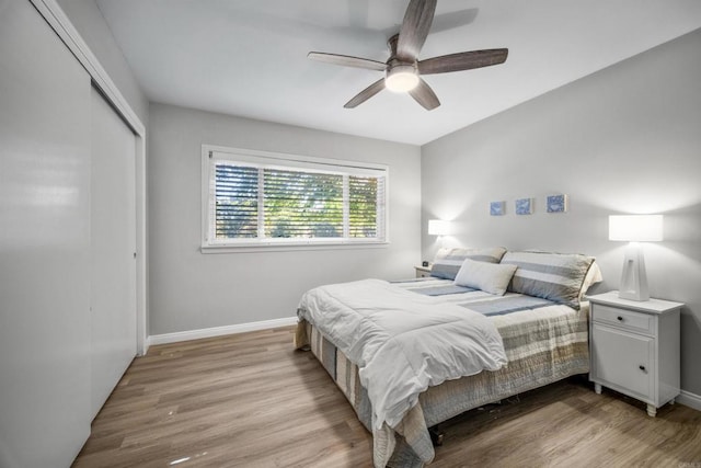 bedroom featuring ceiling fan, a closet, and light hardwood / wood-style flooring