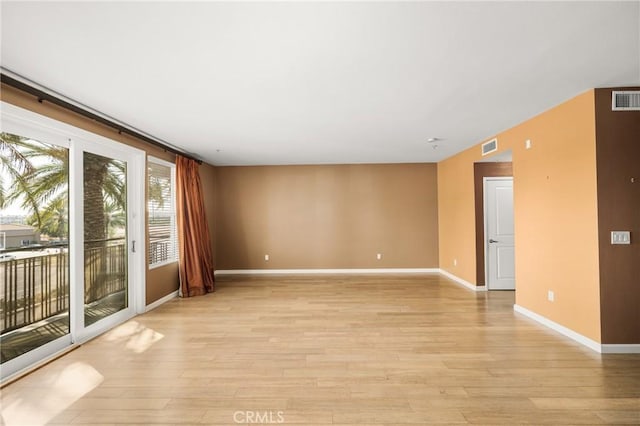 spare room with light hardwood / wood-style flooring