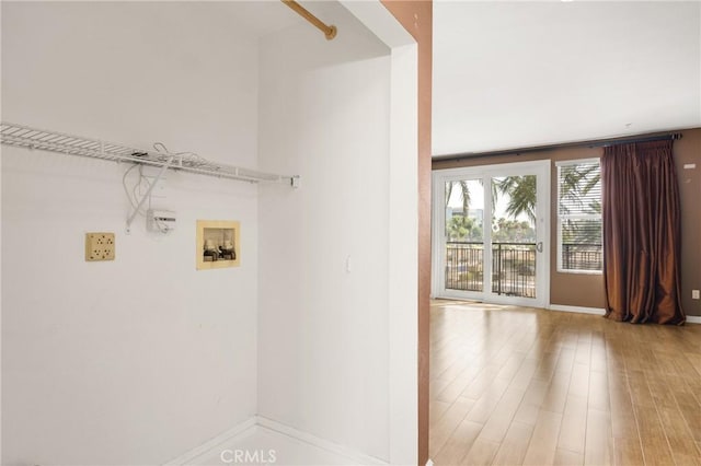 laundry room with wood-type flooring and hookup for a washing machine