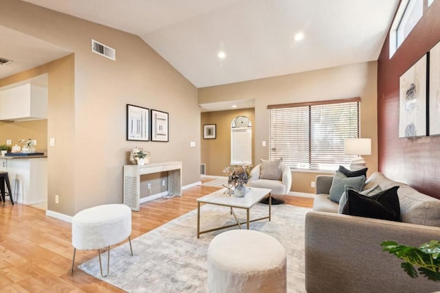 living room with lofted ceiling and light wood-type flooring