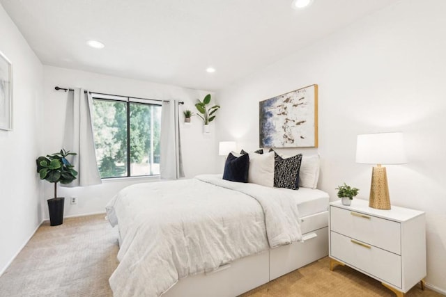 bedroom featuring light carpet