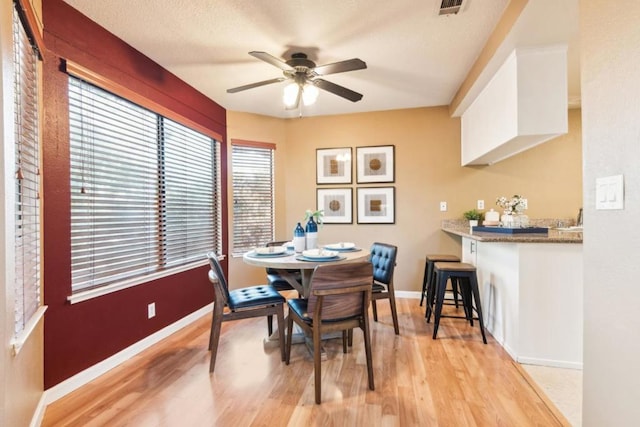 dining space featuring ceiling fan and light wood-type flooring