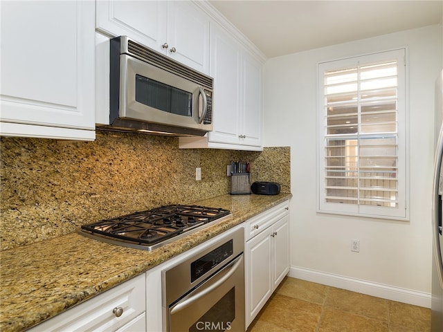 kitchen featuring backsplash, white cabinetry, and stainless steel appliances