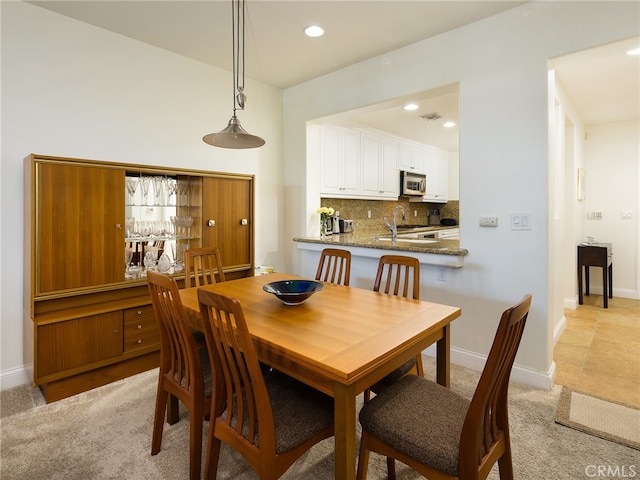 dining room featuring light colored carpet