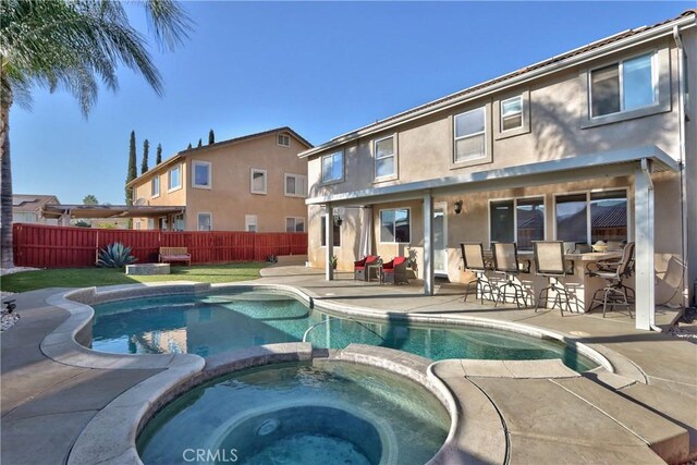 view of pool with an in ground hot tub, an outdoor bar, and a patio area