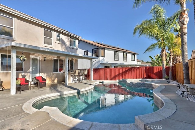 view of swimming pool featuring an in ground hot tub, exterior bar, and a patio