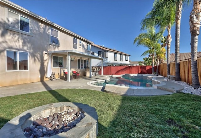 exterior space featuring a patio, a fenced in pool, and a fire pit