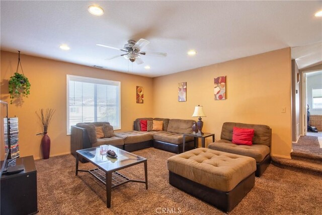 carpeted living room with ceiling fan