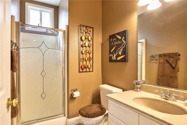 bathroom featuring vanity, toilet, and walk in shower