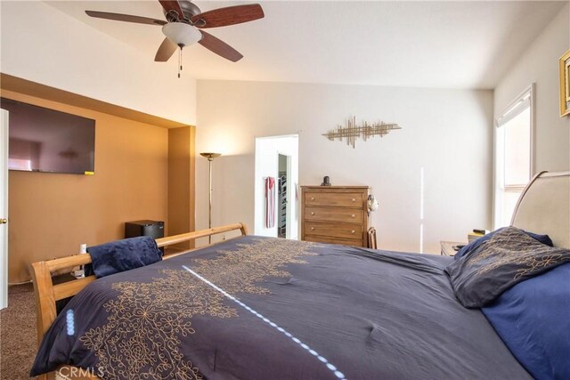 bedroom with ceiling fan, carpet, a spacious closet, and lofted ceiling