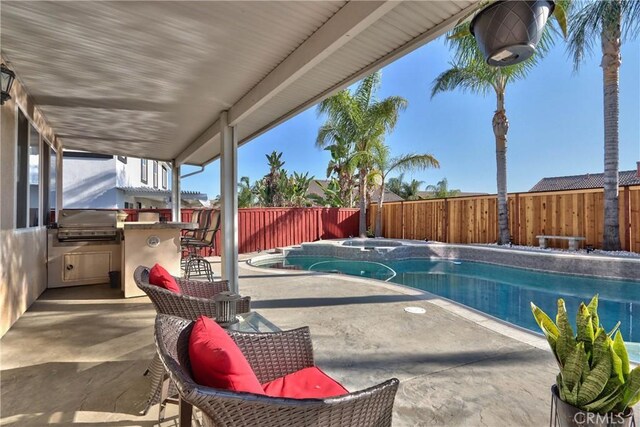 view of pool featuring a grill, a bar, and a patio